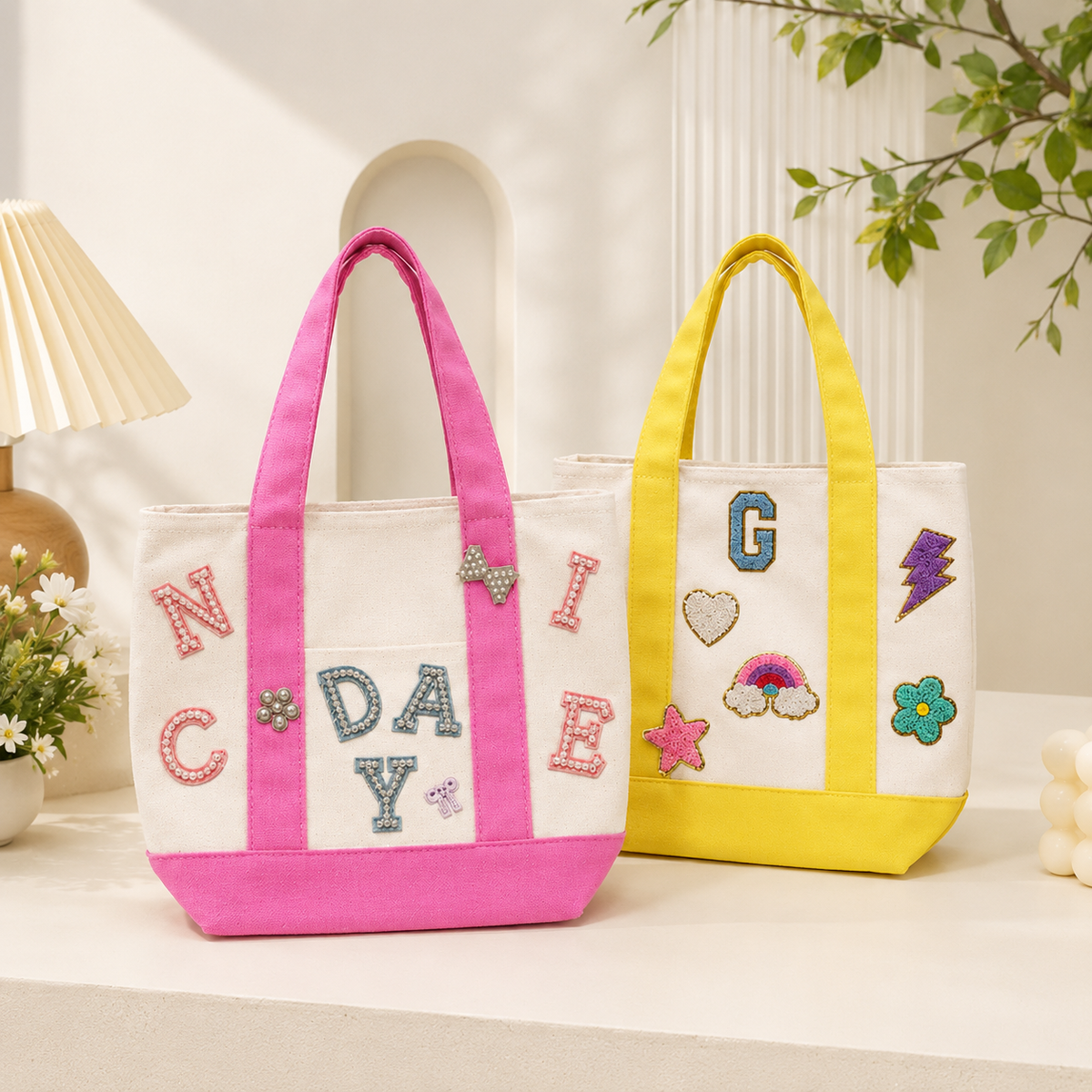 Pink and yellow color block mini canvas tote bags decorated with colorful embroidered letter and icon patches for DIY personalization.